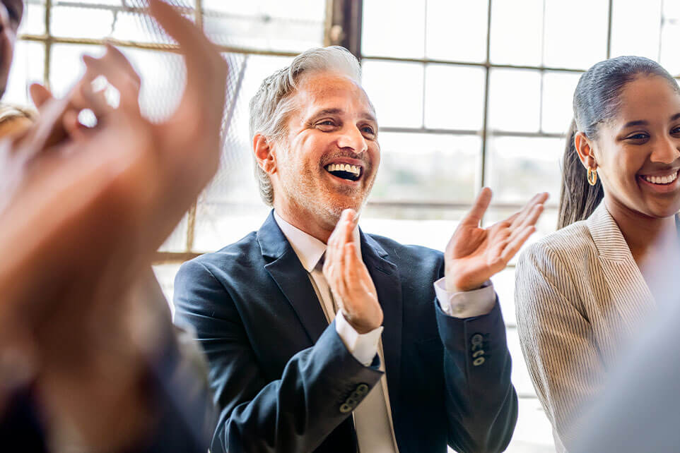 Team of business people clapping