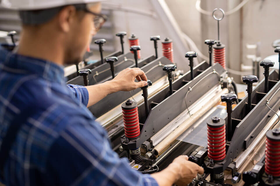 Man working on factory equipment during his shift.