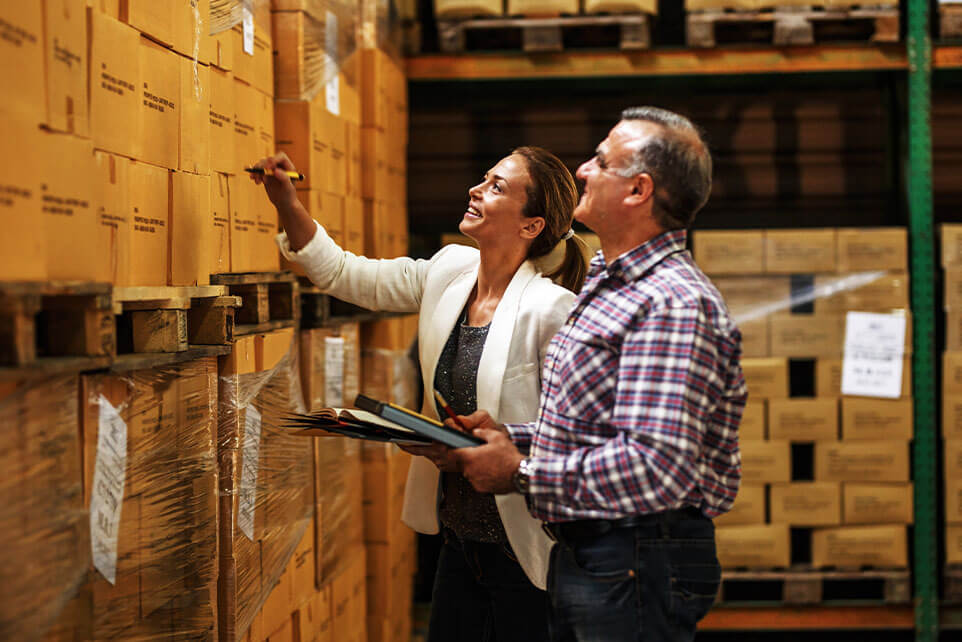 Employees counting inventory in their businesses warehouse.