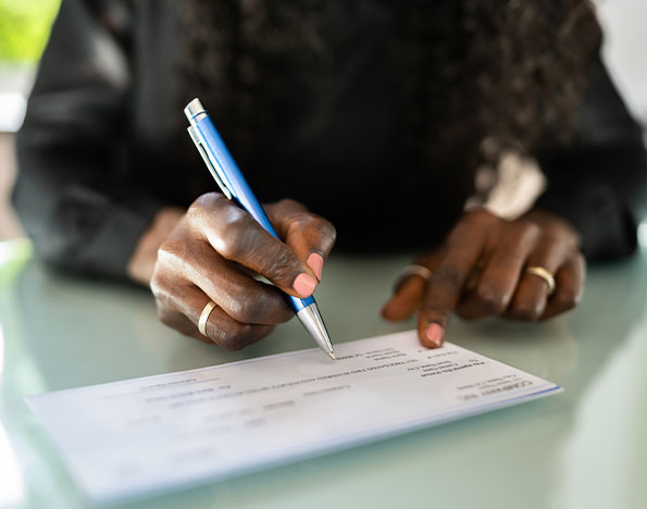 A man writing a check from his savings account.