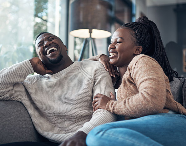 Happy young couple sitting together enjoying their new home!