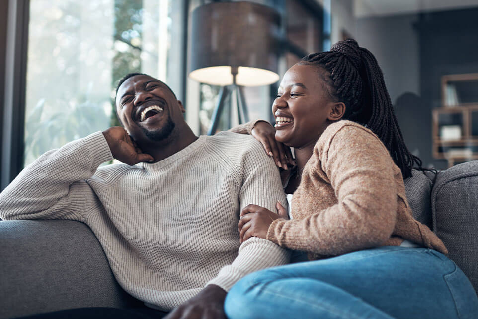 Cropped shot of a happy young couple sitting together and bonding during their weekend at home