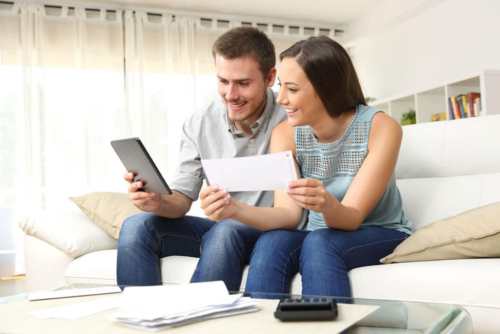 Couple looking at tablet and documents