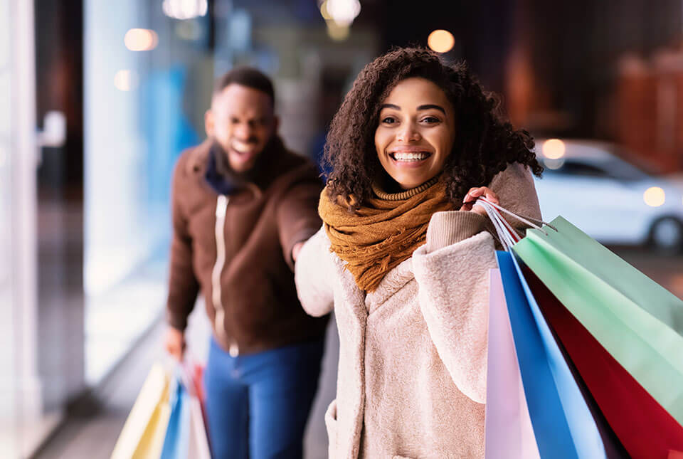 Couple shopping at christmas time getting presents.